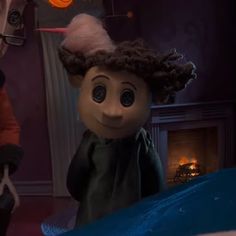 an animated doll is standing in front of a fire place and another character has their hair pulled back