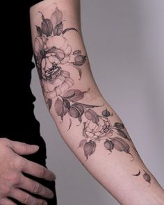 a woman with a flower tattoo on her arm