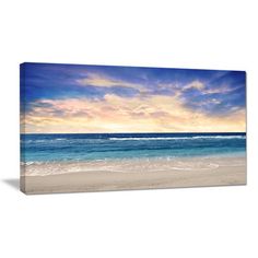 an ocean scene with waves crashing on the beach and clouds in the sky above it