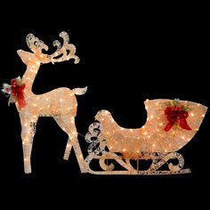 two lighted reindeer sleighs with red bows and lights on the sides, against a black background