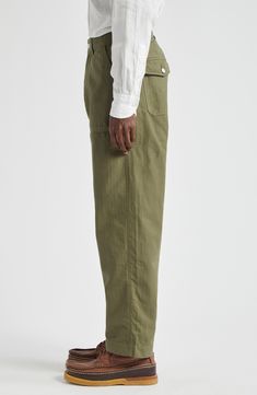 The British haberdasher draws inspiration from military-style fatigues in these herringbone-striped pants cut from a blend of cotton and linen. Zip fly with button closure Front slant pockets 78% cotton, 22% linen Machine wash, line dry Made in Portugal Designer Clothing Spring Cotton Military Pants, Spring Military Style Cotton Pants, Military Style Relaxed Fit Pants For Spring, Military Style Relaxed Fit Straight Leg Pants, Military Style Workwear Bottoms For Spring, Spring Military Workwear Pants, Spring Military Style Workwear Pants, Fatigue Pants, Tweed Trousers