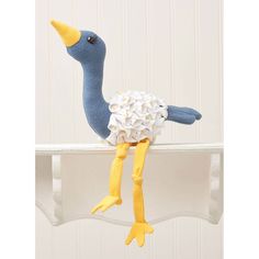 a stuffed bird that is sitting on a shelf