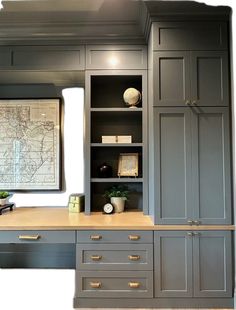 an office with gray cabinets and drawers