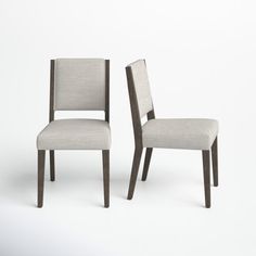 two chairs side by side in front of a white background, one has a gray upholstered seat and the other is a light colored wood frame