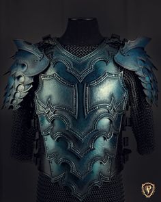 the back of a leather armor with spikes and wings on it's chest, in front of a black background