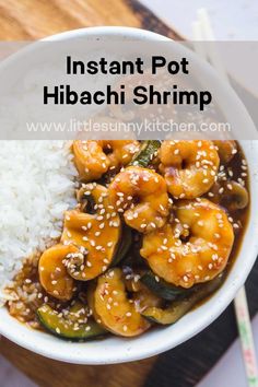 a white bowl filled with shrimp and rice on top of a wooden cutting board next to chopsticks