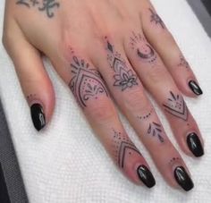 a woman's hand with tattoos on it