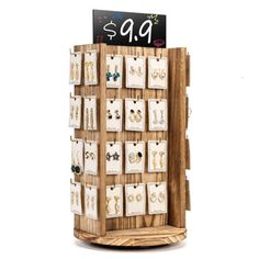 a wooden display with earrings and earring holders on it's sides for sale