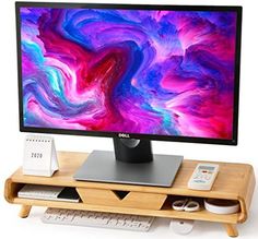 a computer monitor sitting on top of a wooden stand