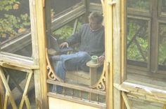 a blurry image of a man sitting on a bench in front of a window