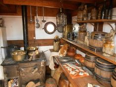 an old fashioned kitchen with many pots and pans