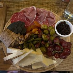 an assortment of cheeses, meats and vegetables on a plate