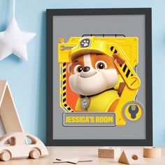 a framed photo of a cartoon character from the movie paw patrol on a blue wall