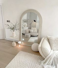 a living room filled with furniture and a large mirror