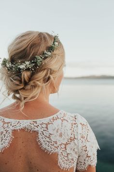 the back of a woman's head with flowers in her hair and an instagram