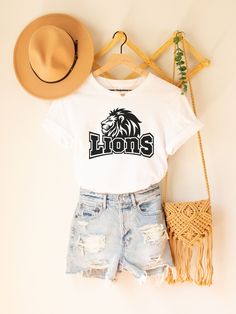 Lion Shirt Women | Lion Mascot Shirt | Lions Football | School Spirit Shirts | Lions Team Shirt | Team Mascot Shirt | Lions Fan ▹ SIZING AND ITEM DETAILS * T-Shirt sizes are UNISEX. Please check photos for detailed measurements. Try comparing the measurements to your favorite t-shirt that fits just the way you like it! * White is 100% combed and ring-spun cotton * Athletic Heather is 90% combed and ring-spun cotton, 10% polyester * Fabric weight: 4.2 oz (142 g/m2) * Pre-shrunk fabric * Side-seamed construction * Design is printed using direct-to-garment (DTG) print on Bella Canvas 3001 t-shirts. All inks used are water-based and eco-friendly. ▹ SHOP POLICIES * Please send us a message if you have any questions before ordering. * Unfortunately, we are not able to accept returns or exchanges Cheap White T-shirt With Mascot, Lions Spirit Wear, Lion Tshirt Design, Softball Designs, Lion Mascot, Mascot Shirt, June Bug, School Spirit Shirts, Lions Football