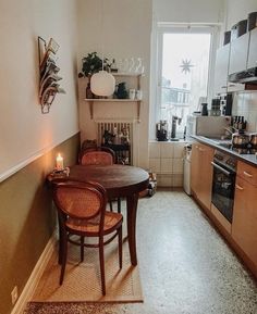 a table and chairs in a small kitchen