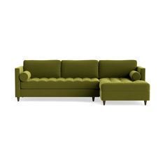 a green sectional couch with pillows on the back and armrests, in front of a white background