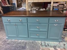 a kitchen island made out of blue cabinets