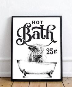 a black and white photo of a cow in a bathtub with the words hot bath on it