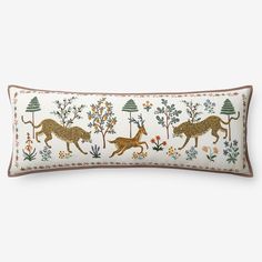 an embroidered pillow with animals and flowers on it