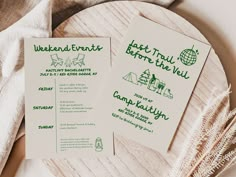 two green and white flyers sitting on top of a wooden table next to a plate