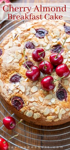 a cherry almond breakfast cake on a wire rack with cherries and almonds around it