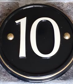 a black and white sign with the number ten on it