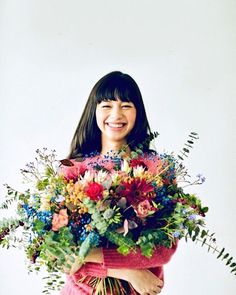 a woman holding a bouquet of flowers in her hands and smiling at the camera with an instagram message below