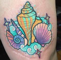 a colorful tattoo with shells and stars on it