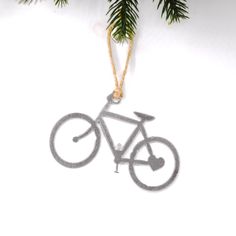 a bicycle ornament hanging from a christmas tree