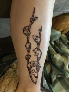 a tattoo on the leg of a woman with flowers growing out of her legs,