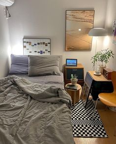 a bed sitting in a bedroom next to a desk