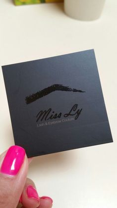 a person holding up a business card with the word miss ly on it and a pink nail polish