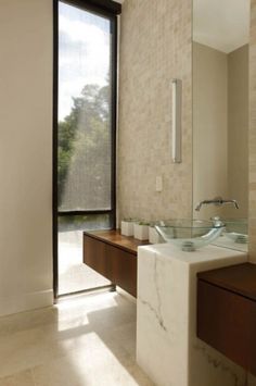 a bathroom with two sinks and a large window