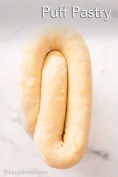 a close up of a doughnut with the words puff pastry on it