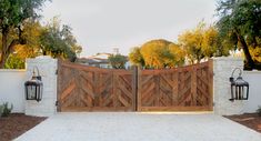 a wooden gate with two lanterns on each side