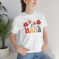 This Groovy Mama T-shirt, featuring a retro floral design is the perfect gift for Mothers. Made of soft, lightweight cotton, this shirt has a standard fit and runs true to size. The shirt is pre-shrunk, but it may shrink slightly with washing. The shirt is available in XS through 3XL sizes, with measurements listed in the sizing chart. Women may want to order a size down for a more fitted look. Please refer to the size chart for the best fit. 100% Airlume combed and ringspun cotton (fiber content may vary for different colors) *Print colors - Actual colors may vary from our listing photo and the final product. We cannot guarantee the color you see on your monitor because of different monitor resolution. The shirt is usually printed after the order is placed, with a turnaround time of 48 ho Spring Casual Shirt With Retro Print, Casual Shirt With Retro Print For Spring, Casual Retro Print Shirt For Spring, Funny Print Multicolor Cotton Top, Funny Multicolor Print Cotton Top, Funny Multicolor Cotton Top, Graphic Tee With Letter Print In Multicolor, Cotton Graphic Tee With Retro Print, Cute Cotton Tops With Floral Print