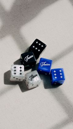 four dices sitting on top of a white surface