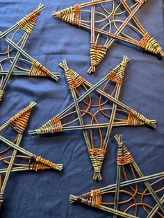 many sticks are arranged in the shape of pyramids on a blue cloth covered table