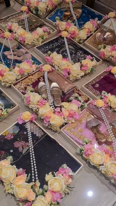 there are many pictures on the table with flowers and pearls around them, including shoes