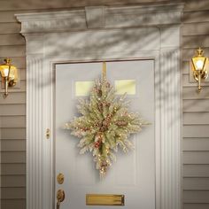 a christmas wreath on the front door of a house