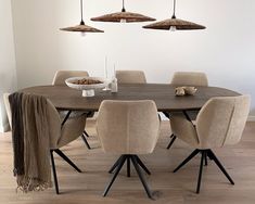 a dining room table with six chairs around it