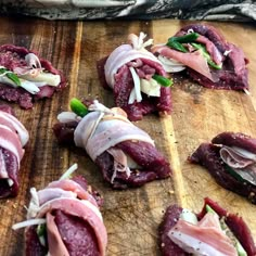 some food is laying out on a wooden cutting board and ready to be cut into bite sized pieces