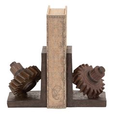 three wooden gears are placed next to each other on a bookend that is made out of wood