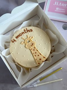 a cake in a box that says i love you to the moon and back with a giraffe on it