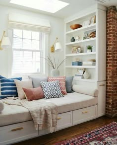 a living room filled with lots of white furniture