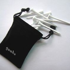 several toothbrushes in a black pouch on a white surface