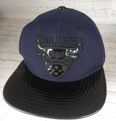 Supply Headwear BULLIES Black and Shiny Black Flat Bill Hat Cap Chicago Bulls.Awesome shape looks unworn. No disappointments. Please message me with any questions before bidding or buying. Including insurance questions. Please Note The Following Not So Fine Print: seller offers no returns. Every effort has been made to describe this item thoroughly and honestly.All sales are final and items are sold AS IS unless otherwise stated. All items are in good working condition unless otherwise stated. P Adjustable Brimmed Baseball Cap For Streetwear, Adjustable Brimmed Snapback Hat For Streetwear, Black Adjustable Brimmed Hat, Vintage Black Fitted Hat With Flat Bill, Vintage Black Fitted Hat For Sports, Black Brimmed Snapback Hat, Vintage Black Fitted Cap, Black Brimmed Snapback Hat For Streetwear, Adjustable Black Brimmed Snapback Hat