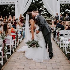 a bride and groom kissing at their wedding ceremony